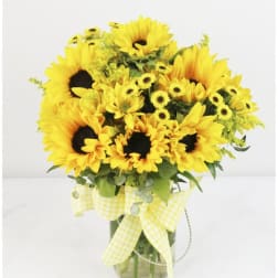 Yellow sunflowers and daisies in a glass vase with a gingham ribbon