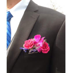 Pink rose boutonniere on a suit jacket lapel
