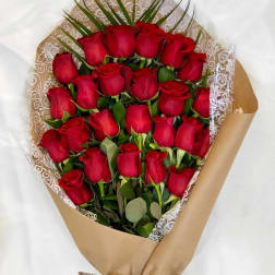 Bouquet of red roses wrapped in brown paper with lace trim