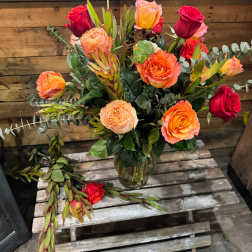 Mixed roses in a glass vase with eucalyptus