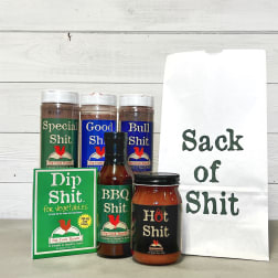 Assorted condiment jars and a white gift bag with bold text.