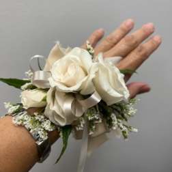White rose wrist corsage with ribbon and small filler flowers