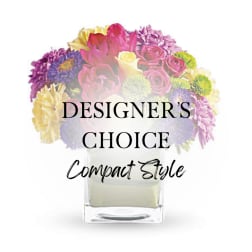 Compact mixed bouquet in a clear square vase