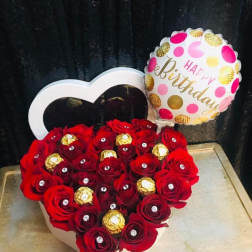 Heart-shaped box of red roses with a birthday balloon