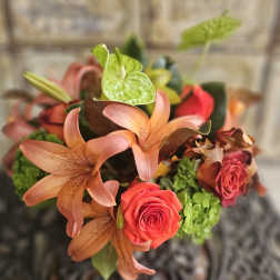 Bouquet of peach lilies, red roses, and green anthuriums