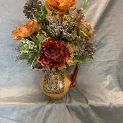 Orange floral arrangement in a decorative ceramic vase
