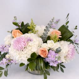 Bouquet of white and pastel flowers in a glass vase