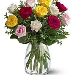 Bouquet of multicolored roses in a clear glass vase
