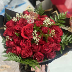 Bouquet of red roses with baby's breath and fern accents