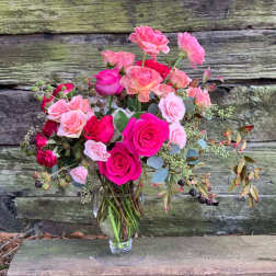 Pink and hot pink roses in a clear glass vase