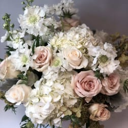 Bouquet of blush roses and white hydrangeas with white flowers