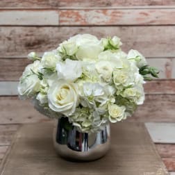 White rose and hydrangea arrangement in a silver vase