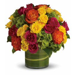 Bouquet of red, pink, yellow, and orange roses in a green glass vase