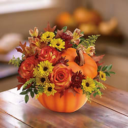 Pumpkin-shaped floral arrangement with orange roses and yellow daisies