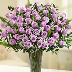 Lavender roses arranged in a clear glass vase