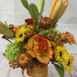 Halloween bouquet with orange roses, yellow daisies, lilies, and glitter pumpkins in a Trick or Treat vase