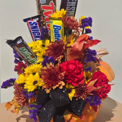 Fall bouquet with chrysanthemums and candy bars in a pumpkin container