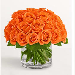 Orange rose bouquet in a clear glass vase