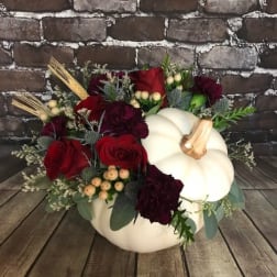 Pumpkin-shaped arrangement with red roses and burgundy flowers