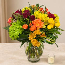 Colorful bouquet of roses and hydrangeas in a glass vase