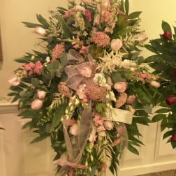 Large pink and white floral standing spray on an easel