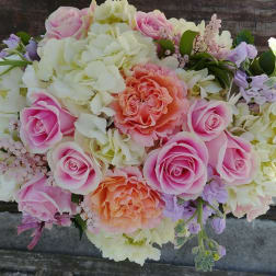 Pink and peach roses with white hydrangeas in a bouquet