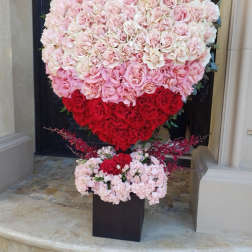 Heart-shaped rose arrangement in pink, white, and red