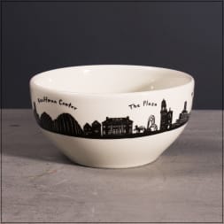 White ceramic bowl with a black city skyline and landmark names around the rim.