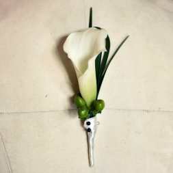 White calla lily boutonniere with green berries and ribbon wrap