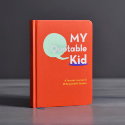 Orange book titled "My Quotable Kid" standing upright
