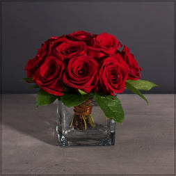 Red rose bouquet in a clear square glass vase