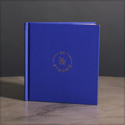Blue hardcover book with gold "Be Strong" logo on the cover