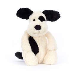 Black-and-white plush dog toy sitting on a white background