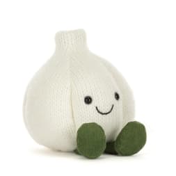 Plush garlic-shaped toy with a smiling face and green feet