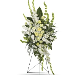 Tall white and pale green floral standing spray on an easel