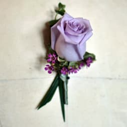 Lavender rose boutonniere with small purple accent flowers