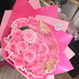 Bouquet of pink roses wrapped in bright pink paper