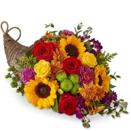Colorful flower arrangement in a woven basket shaped like a bird