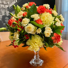Bouquet of red and cream carnations in a clear glass vase