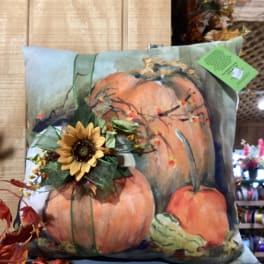 Decorative pillow with pumpkins and a sunflower accent