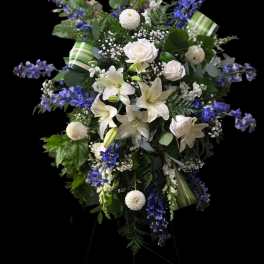 Tall white and blue floral standing spray on an easel