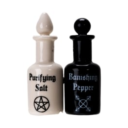 Two ceramic bottles labeled Purifying Salt and Banishing Pepper