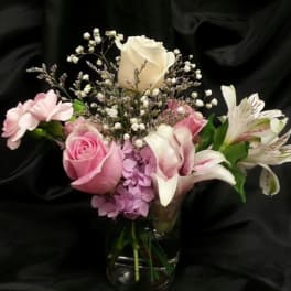 Pink and white bouquet in a glass vase