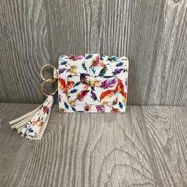 Floral-patterned square keychain wallet with a tassel on a wood surface