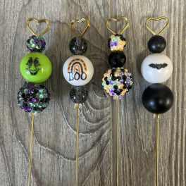 Four Halloween bead picks with heart toppers on gold stems