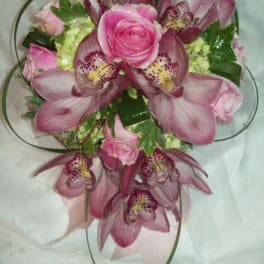 Pink rose and orchid bouquet with ribbon loops