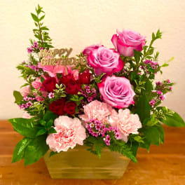 Pink and red rose bouquet with carnations in a vase and a Happy Birthday topper