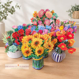 Colorful mixed flower arrangements in small decorative vases on a table