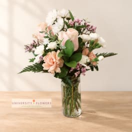 Pink and white mixed bouquet in a clear glass vase