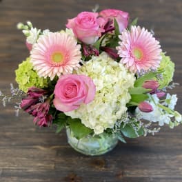 Pink roses and gerbera daisies in a glass vase